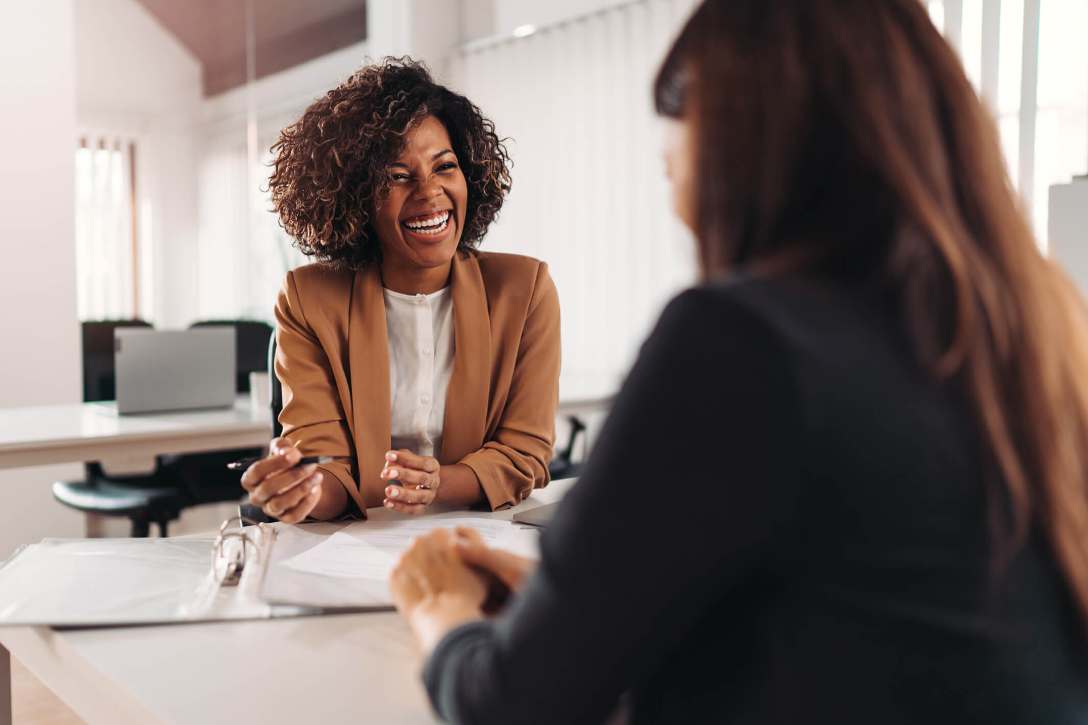 Lindy Sinclair in a consultation with a client that is smiling